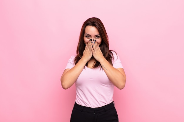 looking happy, cheerful, lucky and surprised covering mouth with both hands