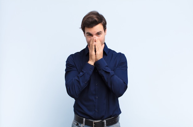 looking happy, cheerful, lucky and surprised covering mouth with both hands