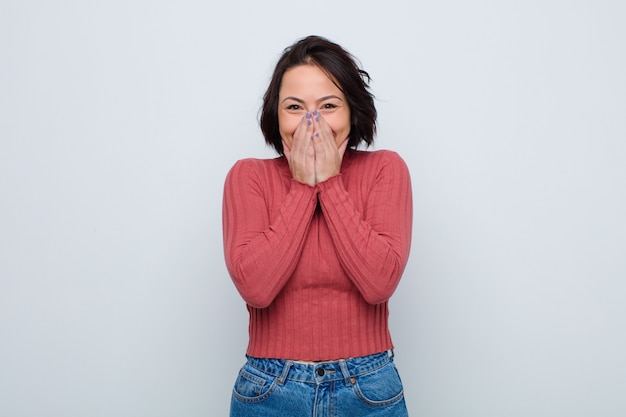 looking happy, cheerful, lucky and surprised covering mouth with both hands