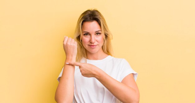 Looking impatient and angry pointing at watch asking for punctuality wants to be on time