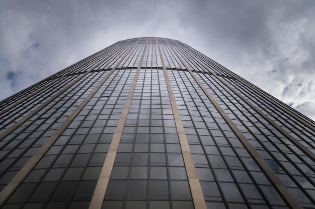 looking into the the sky in front of a skyscraper