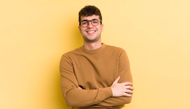 Looking like a happy proud and satisfied achiever smiling with arms crossed