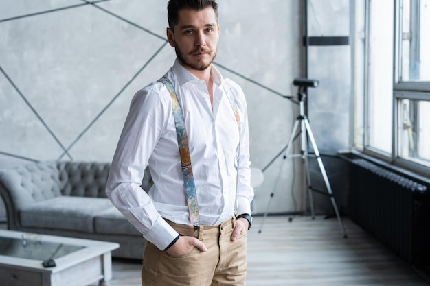 Looking perfect. Full length of handsome young man looking away while standing at home.