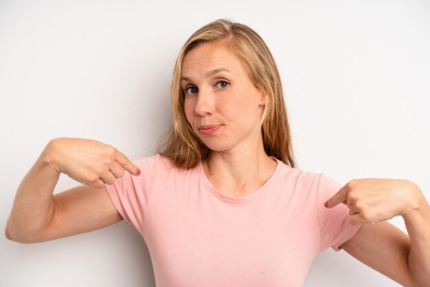 Looking proud positive and casual pointing to chest with both hands