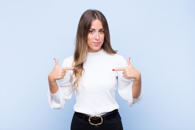 looking proud, positive and casual pointing to chest with both hands