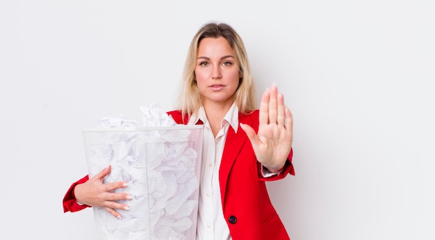 Looking serious showing open palm making stop gesture