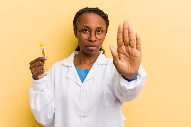 Looking serious showing open palm making stop gesture