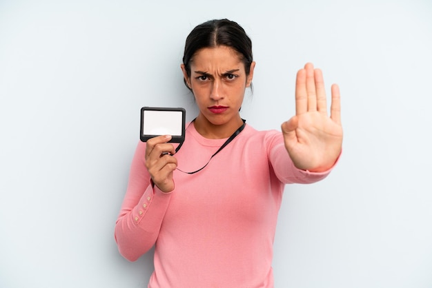 Looking serious showing open palm making stop gesture