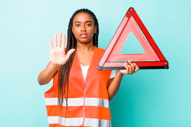 Photo looking serious showing open palm making stop gesture