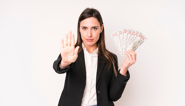 Looking serious showing open palm making stop gesture