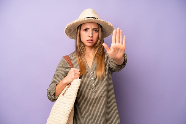 Looking serious showing open palm making stop gesture