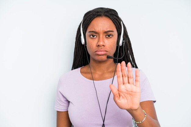 Looking serious showing open palm making stop gesture