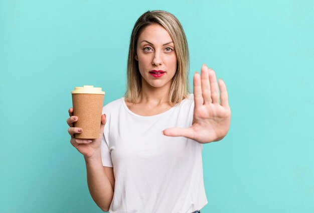 Looking serious showing open palm making stop gesture