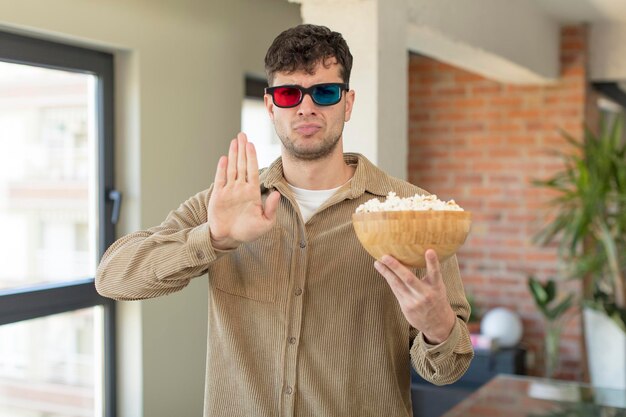 Photo looking serious showing open palm making stop gesture