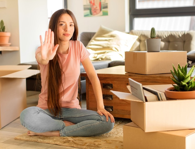 looking serious, stern, displeased and angry showing open palm making stop gesture