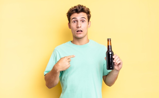 Looking shocked and surprised with mouth wide open, pointing to self. beer bottle concept