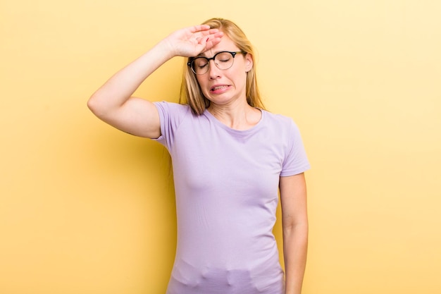 Looking stressed tired and frustrated drying sweat off forehead\
feeling hopeless and exhausted