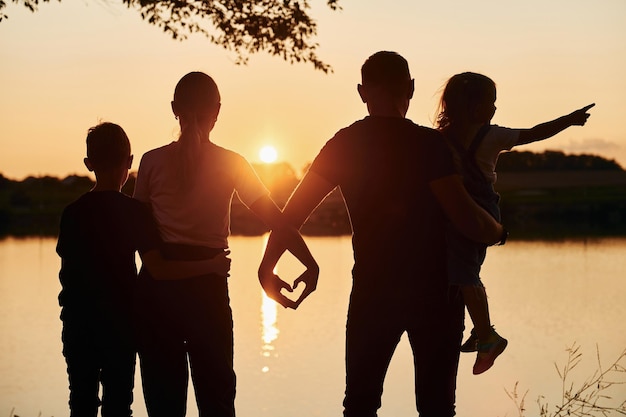 Looking at sunset Family of mother father and kids is on the camping