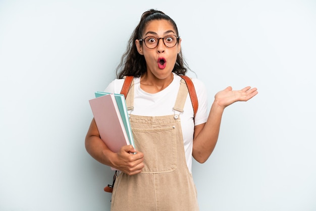 Looking surprised and shocked with jaw dropped holding an object