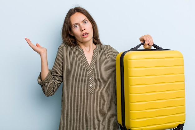 Looking surprised and shocked with jaw dropped holding an object