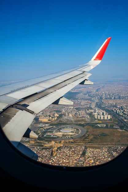 Looking through window aircraft during flight in wing lands over istanbul in sunny weather