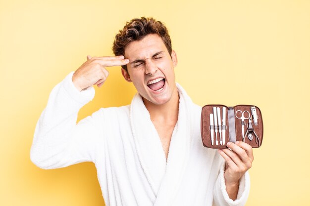 Looking unhappy and stressed, suicide gesture making gun sign with hand, pointing to head. nails tools case concept