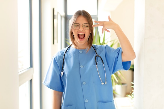 looking unhappy and stressed, suicide gesture making gun sign with hand, pointing to head