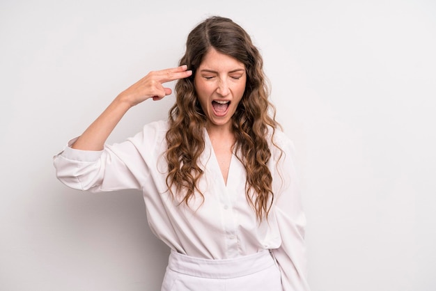 Looking unhappy and stressed suicide gesture making gun sign with hand pointing to head