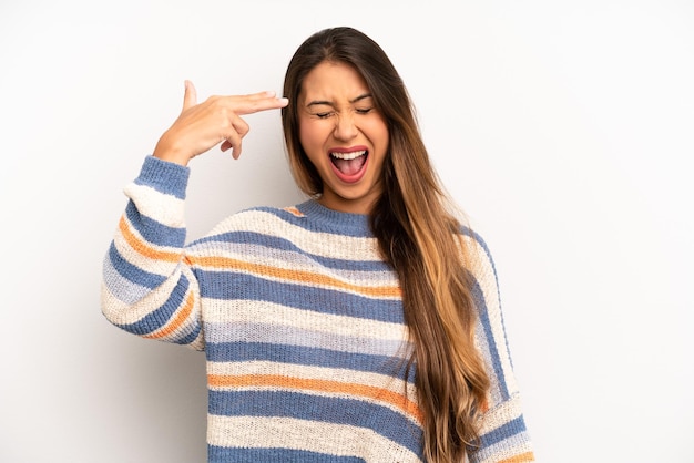 Looking unhappy and stressed suicide gesture making gun sign with hand pointing to head