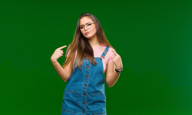 looking unhappy and stressed, suicide gesture making gun sign with hand, pointing to head