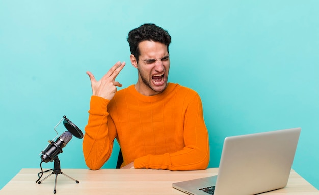 Looking unhappy and stressed suicide gesture making gun sign