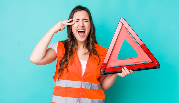 Looking unhappy and stressed suicide gesture making gun sign