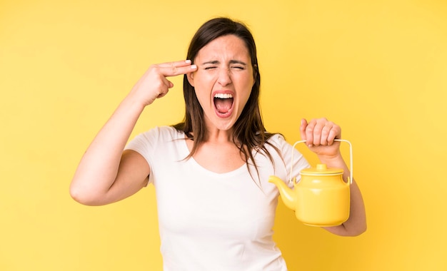 Looking unhappy and stressed suicide gesture making gun sign