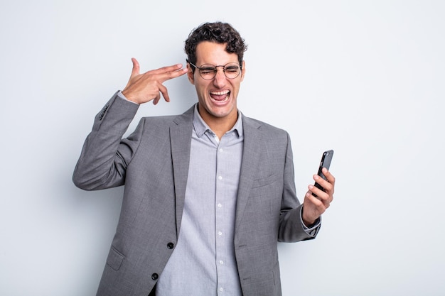 Looking unhappy and stressed suicide gesture making gun sign