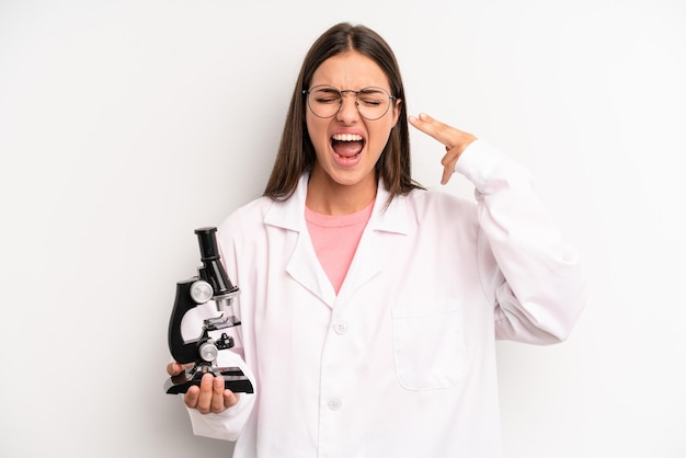 Looking unhappy and stressed suicide gesture making gun sign