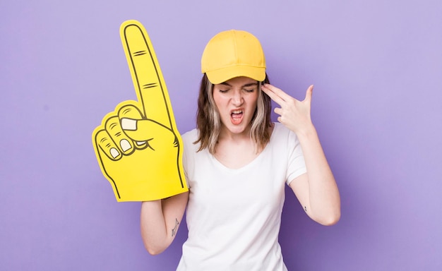 Looking unhappy and stressed suicide gesture making gun sign