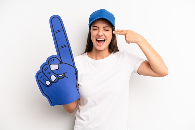 Looking unhappy and stressed suicide gesture making gun sign