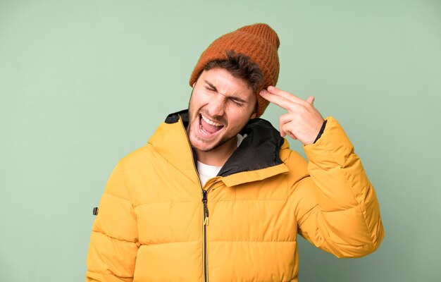 Looking unhappy and stressed suicide gesture making gun sign