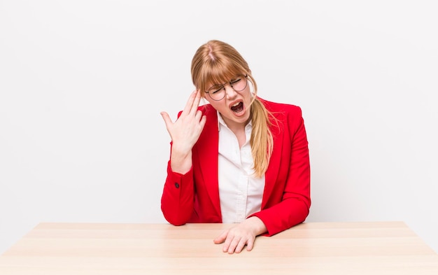 Looking unhappy and stressed suicide gesture making gun sign