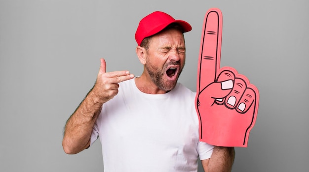 Photo looking unhappy and stressed suicide gesture making gun sign