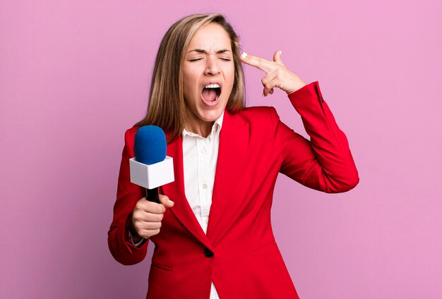 Looking unhappy and stressed suicide gesture making gun sign