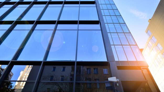 Looking up blue modern office building The glass windows of building with aluminum framework