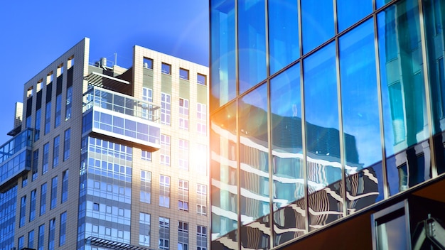 Looking up blue modern office building the glass windows of building with aluminum