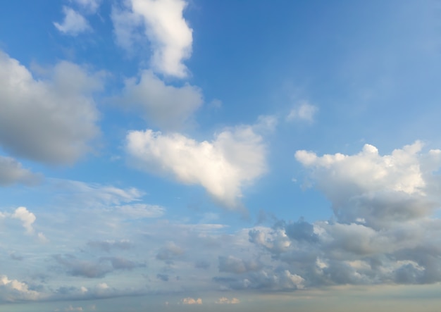 Looking up at the blue sky and white clouds background