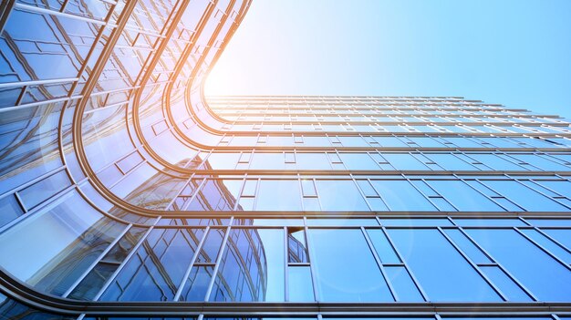 Looking up at the commercial buildings in downtown Modern office building against blue sky