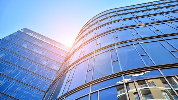 Looking up at the commercial buildings in downtown Modern office building against blue sky