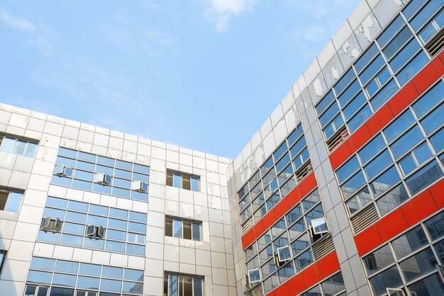 Looking up at the glass facade of a skyscraper