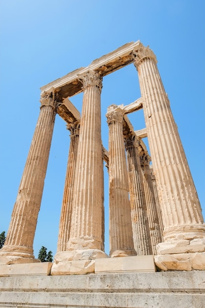 Looking up view of famous Greek temple pillars against clear blue sky in Temple of Zeus, Greece