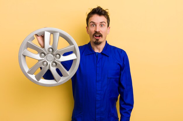 Looking very shocked or surprised car repairman concept