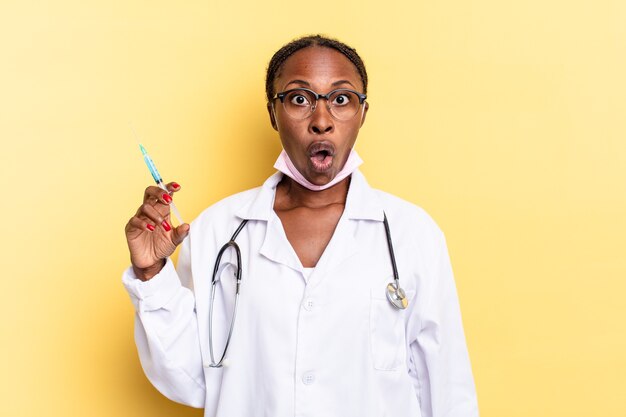 Looking very shocked or surprised, staring with open mouth saying wow. physician and syringe concept